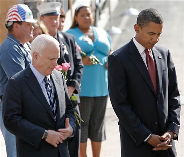McCain and Obama bow their heads.